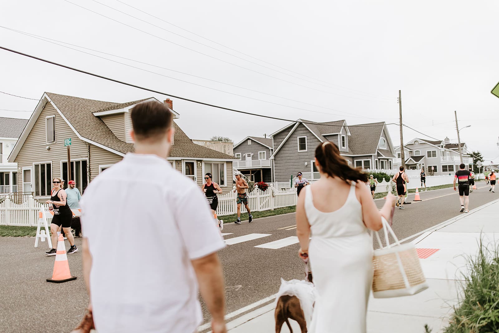 View of the Escape the Cape Triathlon with Noel, Justin, and their dog walking toward the blocked-off streets