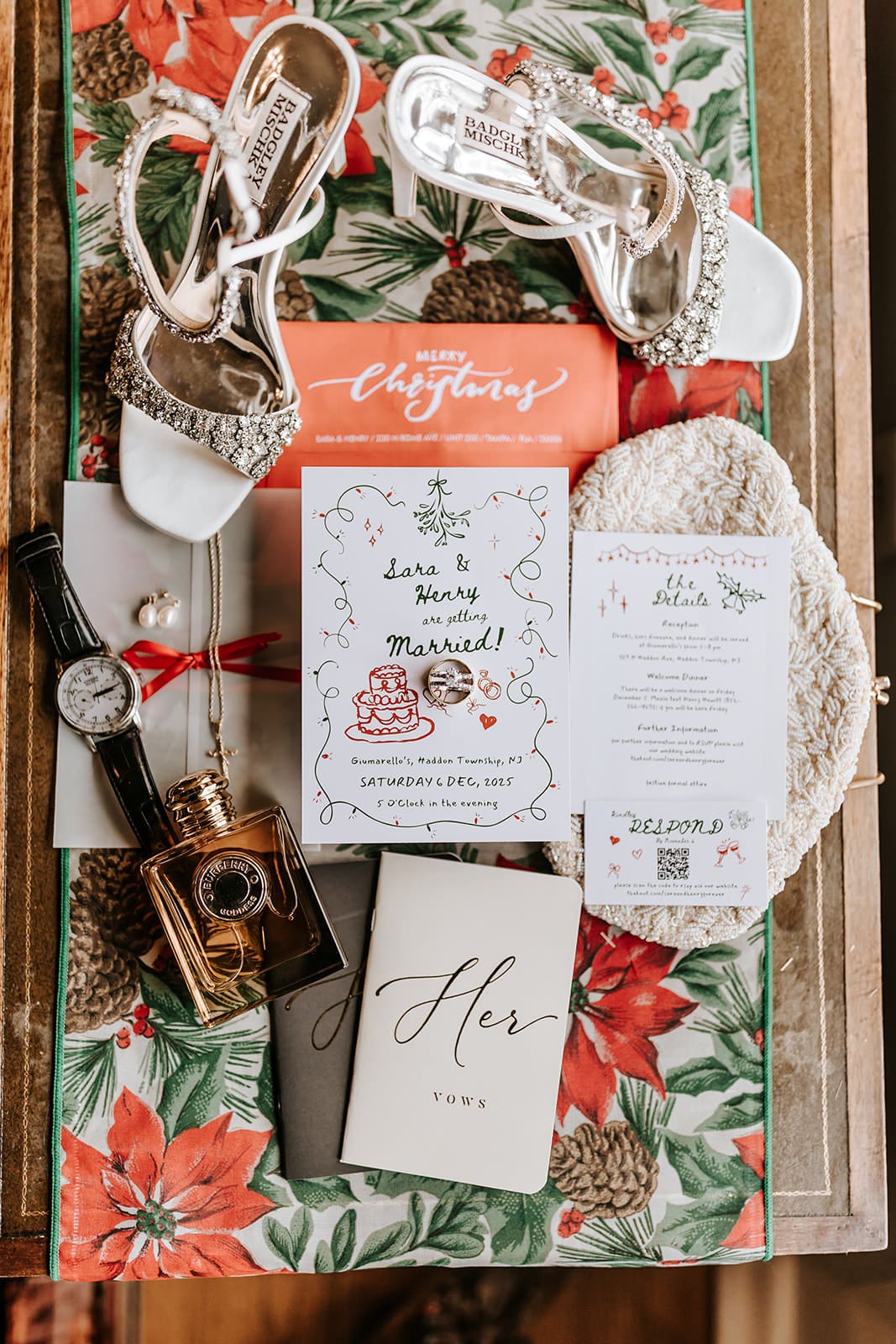 Flat lay of Christmas wedding details including bridal shoes, invitations, vows booklet, and holiday-inspired styling for a December wedding in Haddonfield, New Jersey.