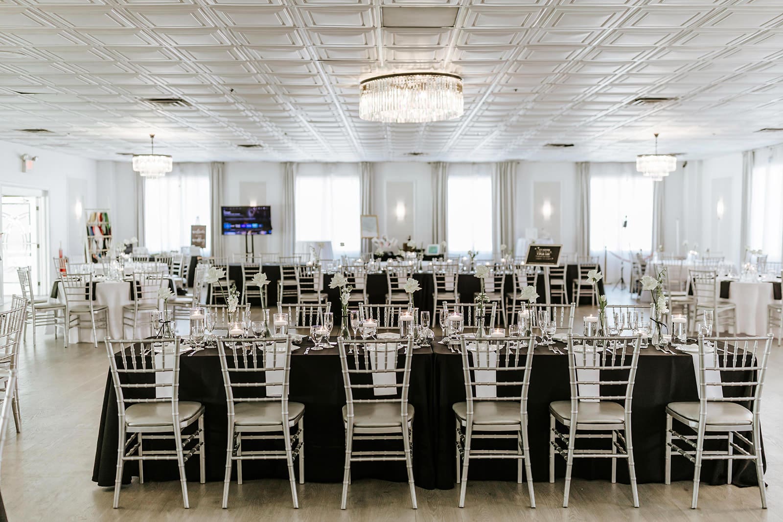 The Grace Ballroom at Valleybrook Country Club set for a wedding reception, showcasing new chandeliers, elegant table settings, and a refined South Jersey country club wedding venue.