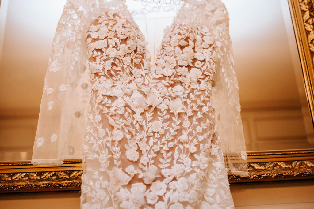 Wedding dress hanging on mirror at Stotesbury Mansion