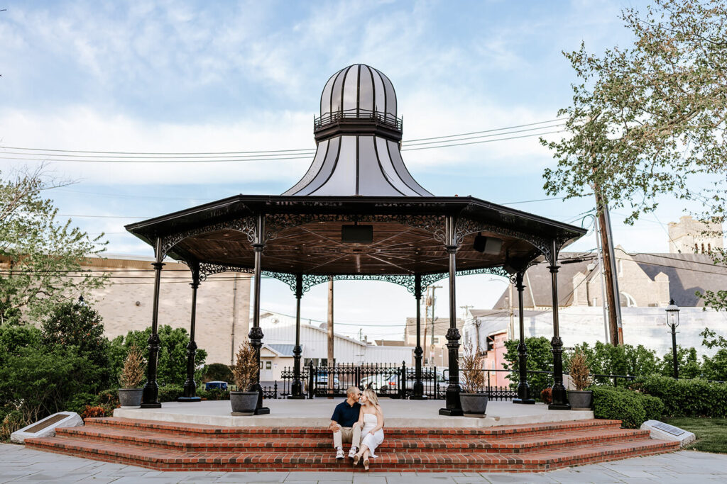 Couple sitting under the historic victorian gazebo during their Cape May engagement session.