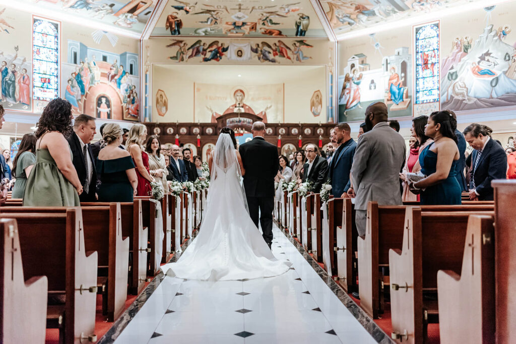 Bride walking down the aisle during a Greek Orthodox wedding ceremony in Cherry Hill NJ