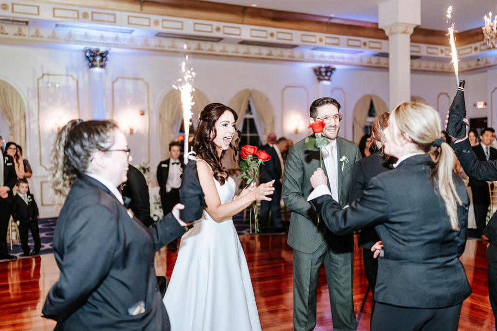 Bride, groom, and wedding party celebrating during the reception at The Merion wedding venue