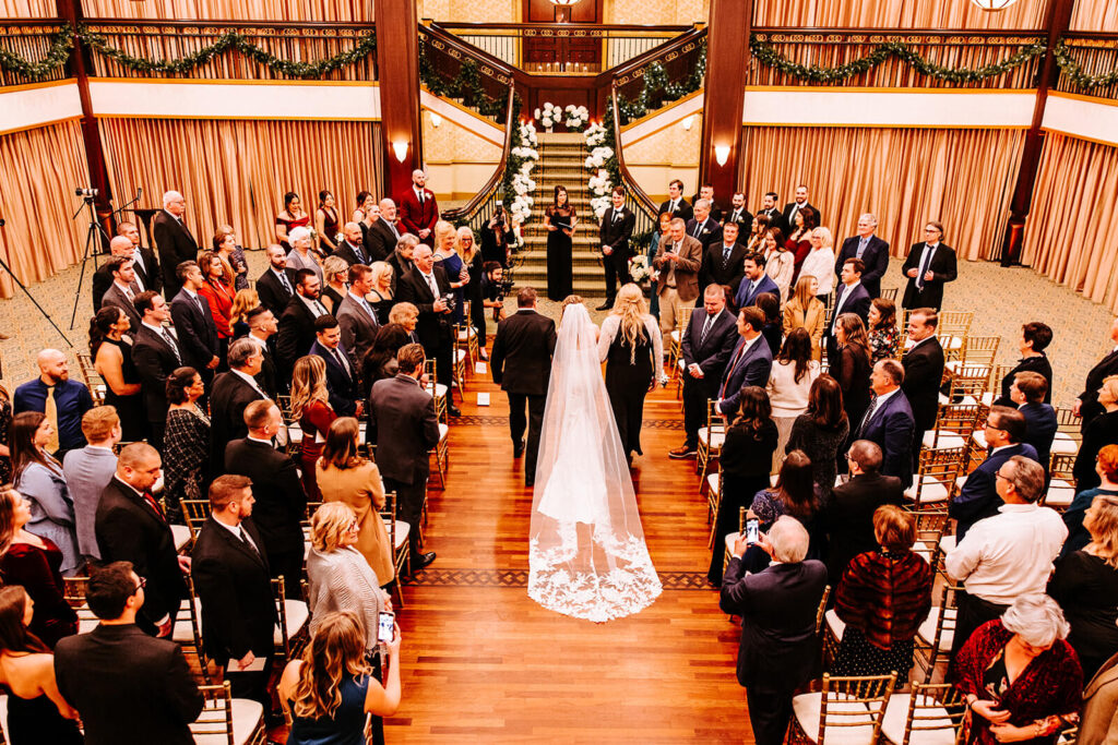 Bride walking down the aisle during the indoor ceremony at Collingswood Grand Ballroom