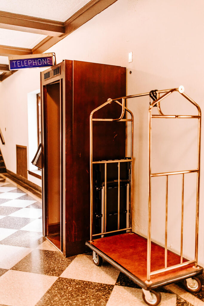Vintage phone booth and luggage cart inside Collingswood Grand Ballroom