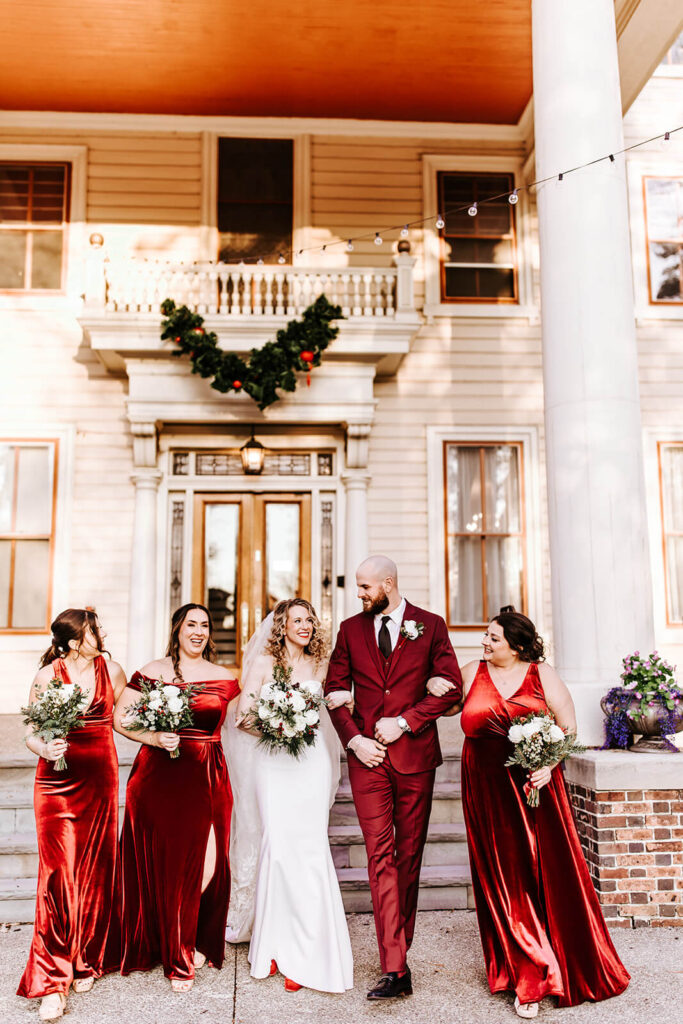 Bridesmaids and groomsmen posing outside the historic Collingswood Grand Ballroom