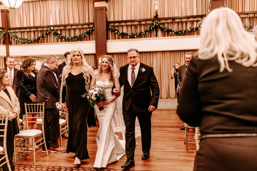 The wedding party walked proudly down the aisle following the ceremony.