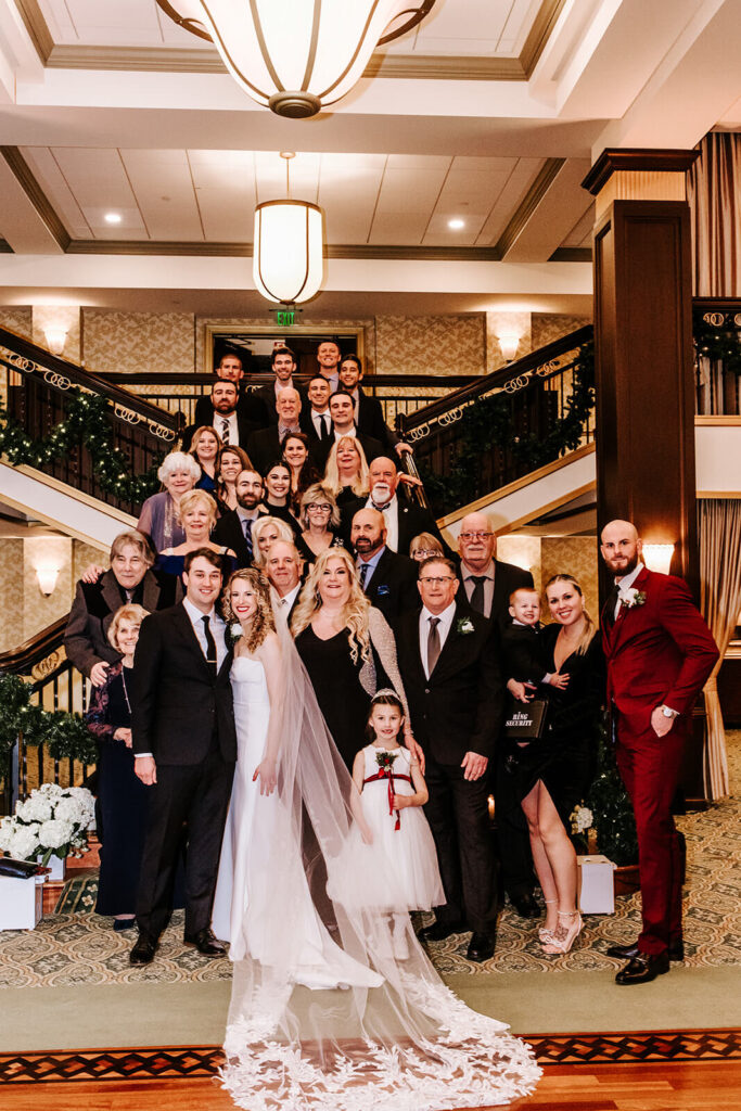 Wedding party portrait on the historic staircase at Collingswood Grand Ballroom