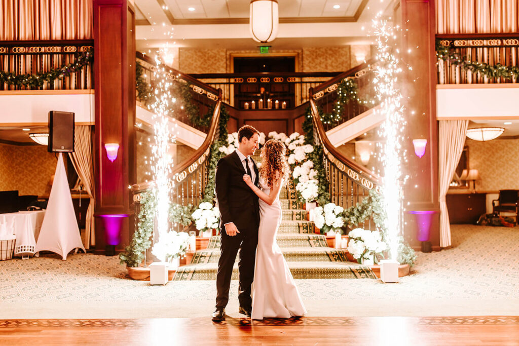 Romantic wedding portrait in front of the illuminated grand staircase at Collingswood Grand Ballroom