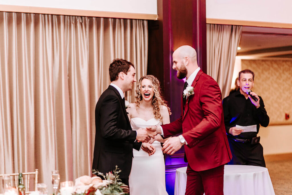 Bride and groom laughing during their Collingswood Grand Ballroom wedding reception in South Jersey